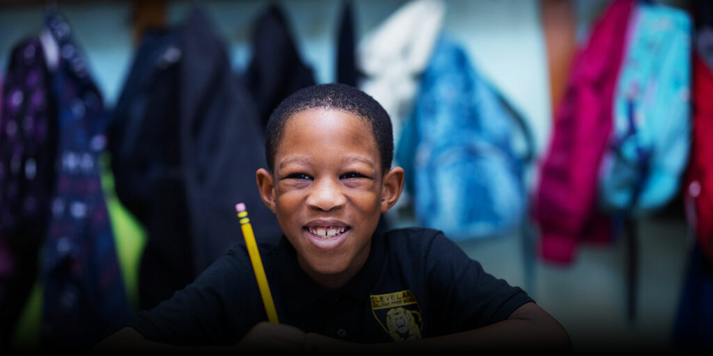 Smiling student in a classroom.